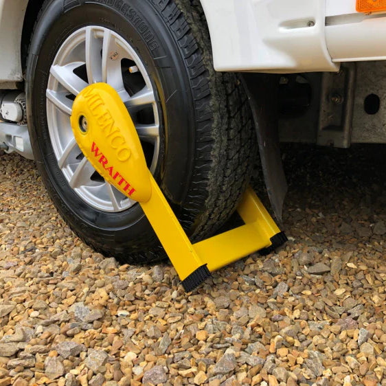 Milenco Compact Wheel Clamp / Wraith fitted to a caravan tyre on gravel — secure wheel locking system – Comparing Milenco Wraith 3 Caravan Wheel Lock Clamp vs Foam Wheel & Trim Protector for Wheelclamp (2 Strips): Which is Right for You?
