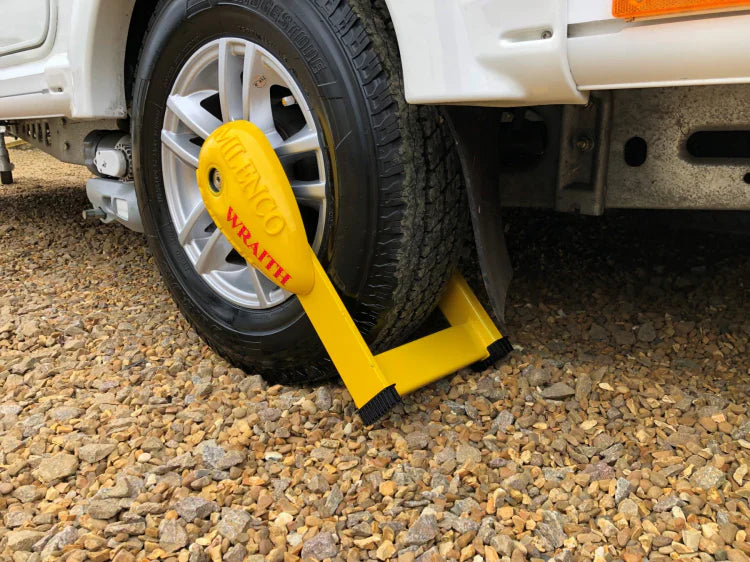 Milenco Compact Wheel Clamp / Wraith fitted to a caravan tyre on gravel — secure wheel locking system – Comparing Lock & 3 Keys (Wheelclamp) vs Milenco Wraith 3 Motorhome Wheel Lock Clamp: Which is Right for You?