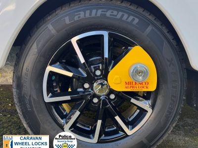 Milenco Alpha wheel lock fitted to a caravan — Sold Secure rated wheel clamp – Everything You Need to Know About Milenco Alpha Diamond Wheel Lock 7757 – Yellow – Caravan Security Clamp
