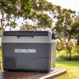 myCOOLMAN cool box on a picnic bench in a sunny summer field — portable cooler in real-world use – Essential Maintenance Tips for myCOOLMAN Coolers & Ice Boxes