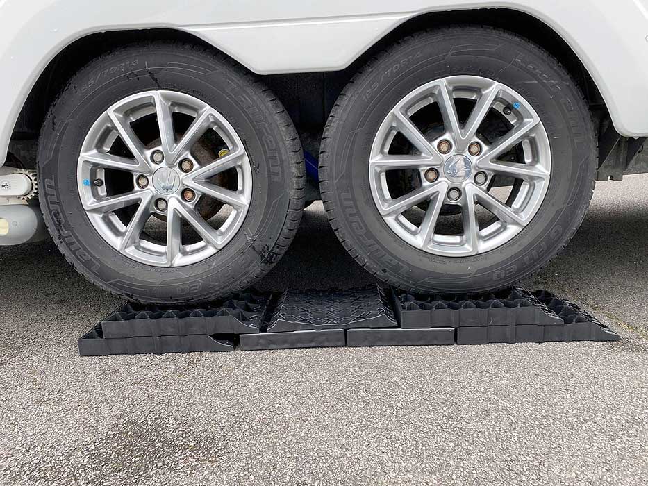 Milenco Stacka Level 9 levelling set in use under two caravan wheels — multi-level ramp for serious height differences – Top 10 Stacka Level Systems & Corner Feet Every Caravan Owner Needs