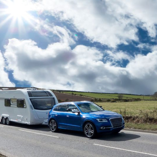 Caravan being towed along a country road — safe and stable touring with proper towing setup – Why Milenco Swiss Luxx Cordless Kettle – Low-Wattage 1.2 L – Clear-View Body – Caravan/Motorhome is Essential for Safe Towing