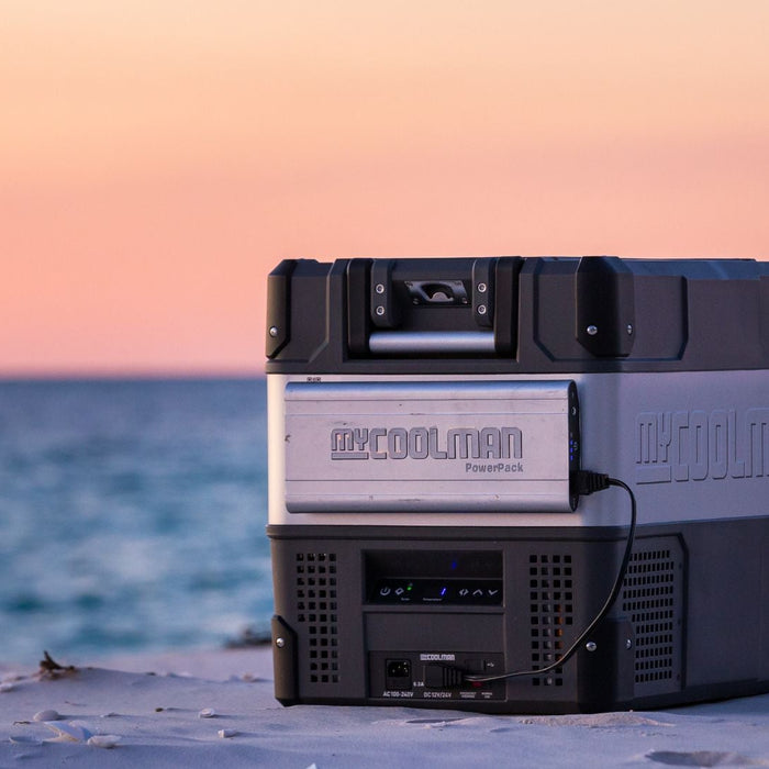 myCOOLMAN portable fridge/freezer in use on a beach at sunset — lifestyle shot of the cooler outdoors – Complete Buying Guide: myCOOLMAN Single Zone Fridge / Freezers