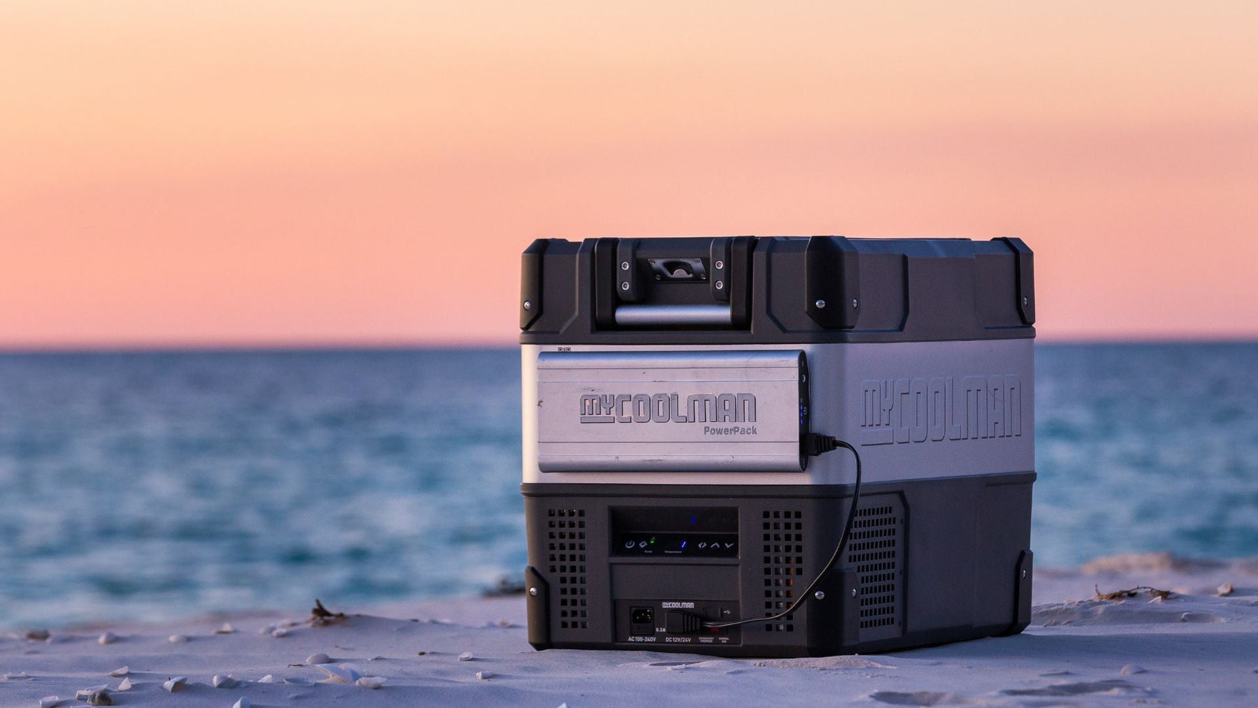 myCOOLMAN portable fridge/freezer in use on a beach at sunset — lifestyle shot of the cooler outdoors – Complete Buying Guide: myCOOLMAN Dual Zone Fridge / Freezers
